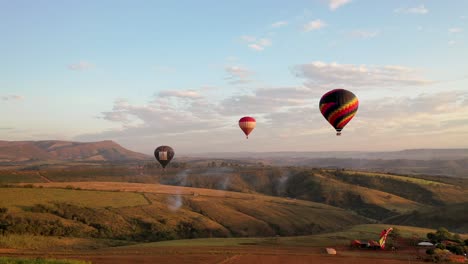 Drone-view-of-the-flight-of-three-balloons-at-the-Balloon-Festival-in-Serra-da-Canastra-in-the-interior-of-Minas-Gerais,-Brazil