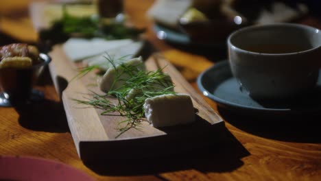 close up shot of cheese selection board on table at bright restaurant