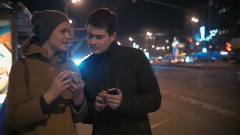 man taking girls phone number in the street