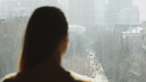 woman looking out the window