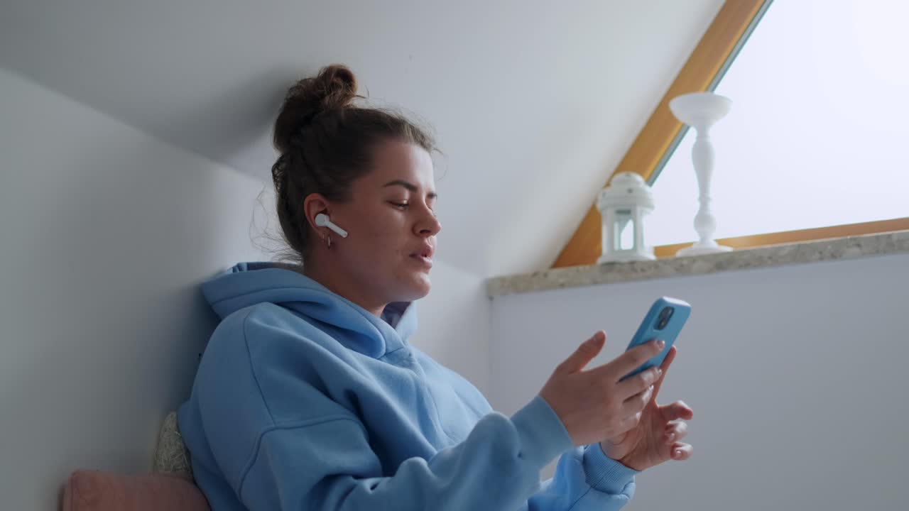 Donna che si Rilassa a Casa Ascoltando Musica e Usando il Telefono