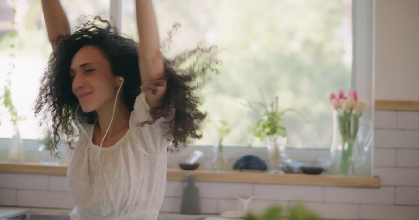 Handheld shot of a female freely dancing