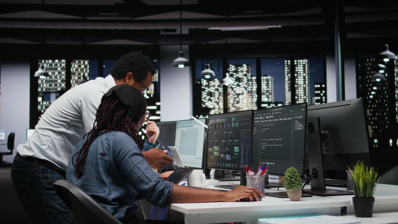 Diverse Team of Programmers Collaborating on Software Development in Modern Office at Night