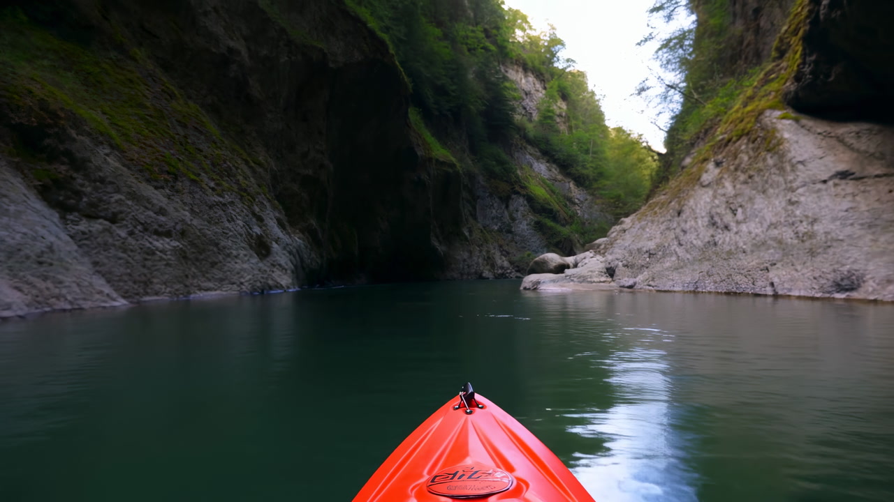 Kayak Bow Gliding Through Narrow Canyon, Emerald Water Reflecting Mossy Stone Walls, Closeup Hands Paddling