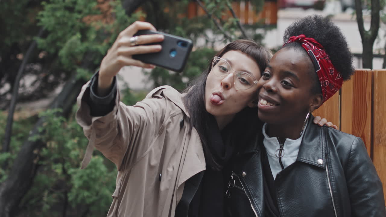Happy Lesbian Couple Taking Selfie Outside