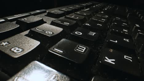 camera flyover over a black russian-english keyboard.