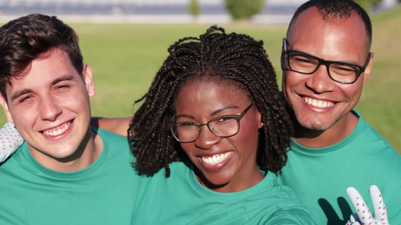 Happy volunteers smiling at camera