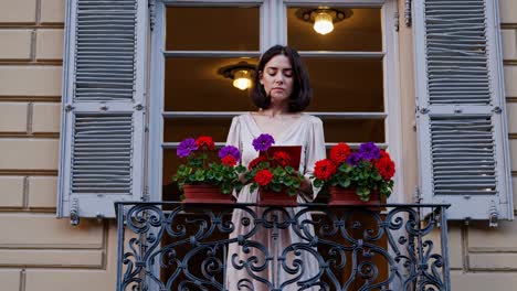 woman on a balcony with flowers