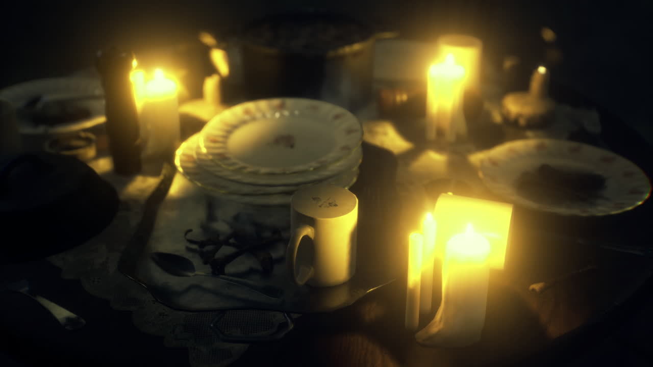 Candlelit dinner setting with vintage plates and silverware on an ornate table