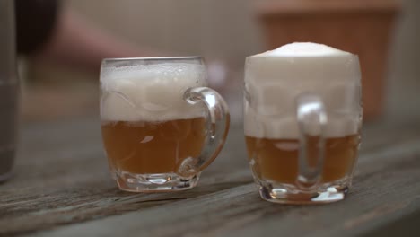 glass of beer on bench outdoors