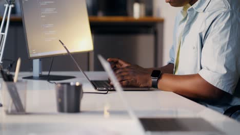 person coding on laptop in office