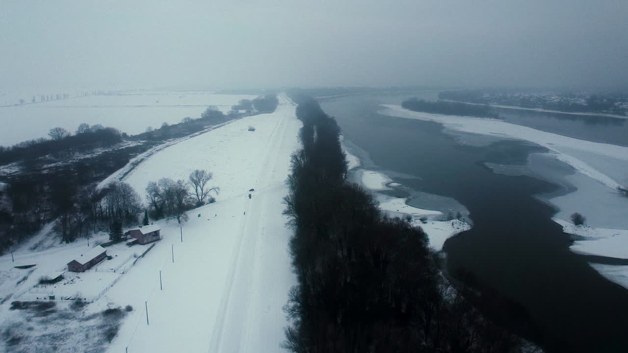 Ansa ghiacciata del Danubio che mostra ghiaccio spesso e costa invernale, sentiero forestale lungo le rive alberate, dolly aereo stabilito