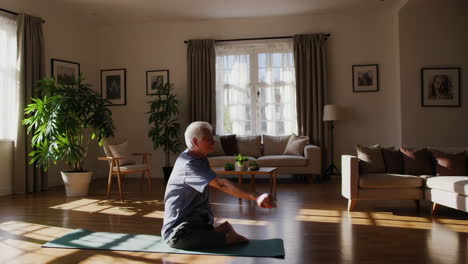 senior man doing yoga at home