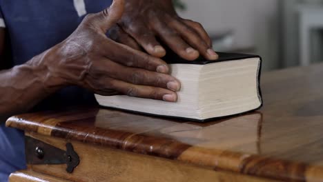 man-praying-to-God-with-hand-on-bible-with-people-stock-video-stock-footage