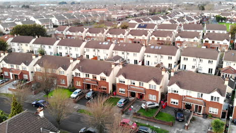 Aerial---A-residential-of-Lucan,-a-cold-day-with-a-view-above-the-houses-from-the-sky-in-a-large-village-of-Dublin-city-centre,-Ireland,-Europe