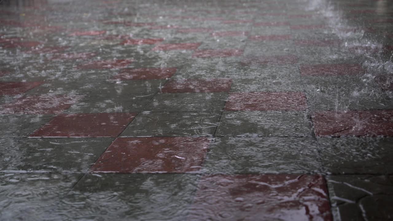 Raining drop on concrete floor in rainy day.