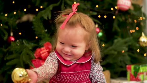 adorable toddler girl with christmas ornament