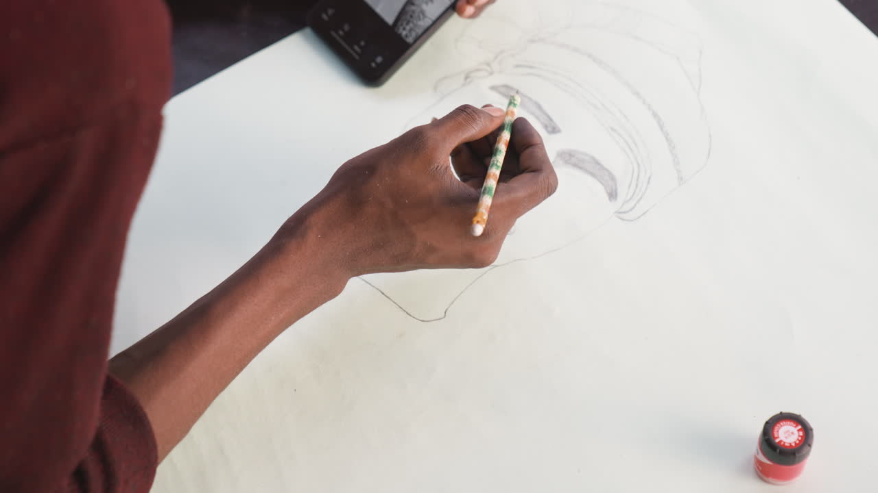 Artist sketching demonstration. Drawing with shading and contrast. Practicing tonal variations on textured paper. Closeup of artist refining pencil shading techniques with reference tools