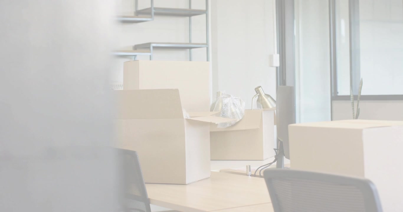 Scan lines fading and clearing, revealing packed office desks, boxes, lamp preparing relocation