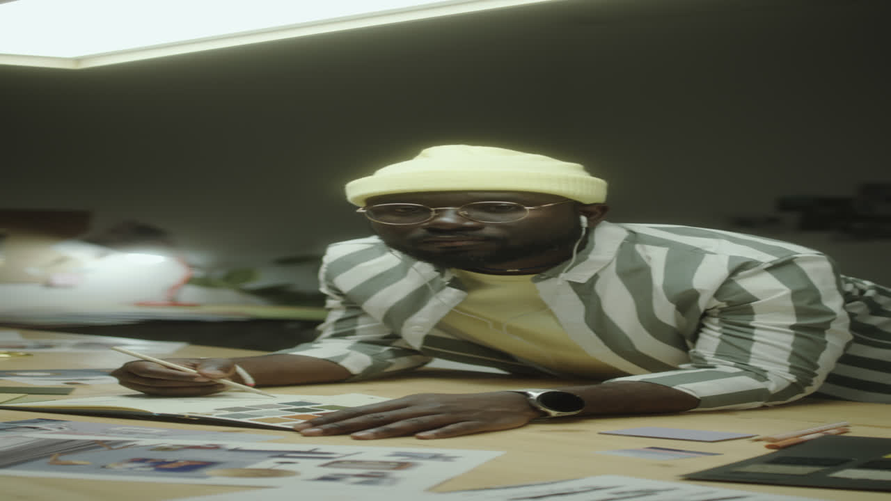 Portrait of Black Designer at Workplace at Night