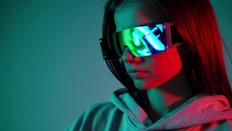 young woman in futuristic holographic glasses with neon lighting