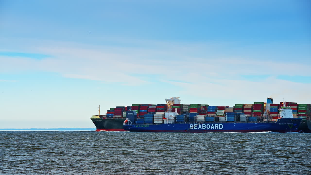 New York, USA, 25 December 2025: Seaboard Venture LNG powered cargo ship in open water. Blue Seaboard Venture container ship with LNG powered text sailing on a calm sea under a clear sky