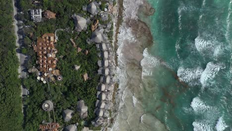 aerial top-down rising over azulik resort eco-lodge at tulum, mexico
