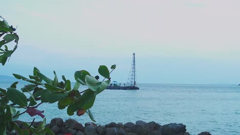 People-works-on-drill-platform-in-sunset-time