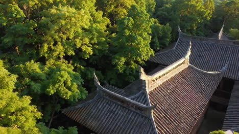 aerial view of a chinese temple surrounded by lush trees