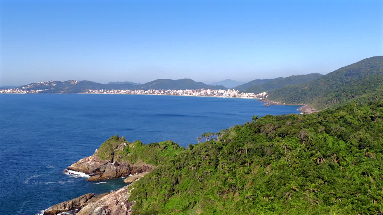 Drone dolly shot forward revealing the lush coastline and beaches of Bombas and Bombinhas