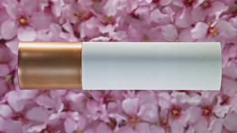 Cosmetic-packaging-on-a-background-of-pink-almond-blossoms,-water-wave-effect