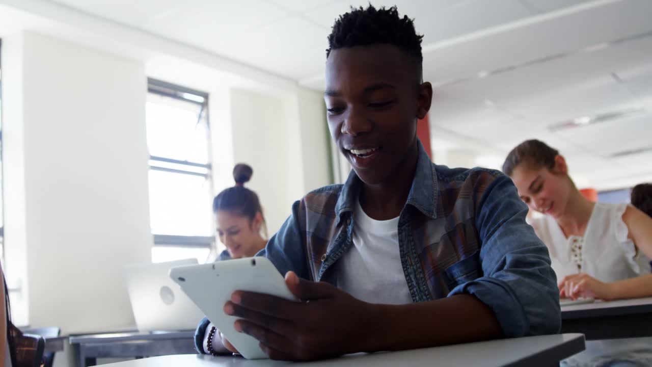 High school students using digital tablet in classroom