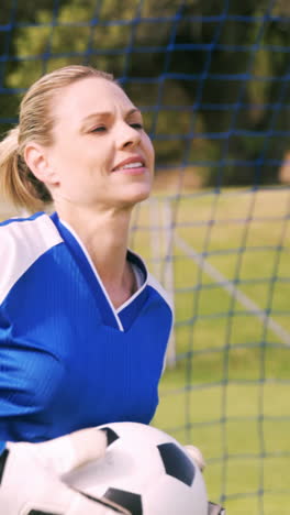 goalkeeper in blue making gesture