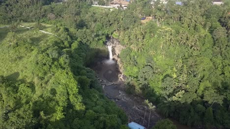 AERIAL-ORBIT-VIEW-of-Tegenungan-Waterfall-in-Bali,-Indonesia,-Cascade-in-forest,-with-surrounding-wilderness