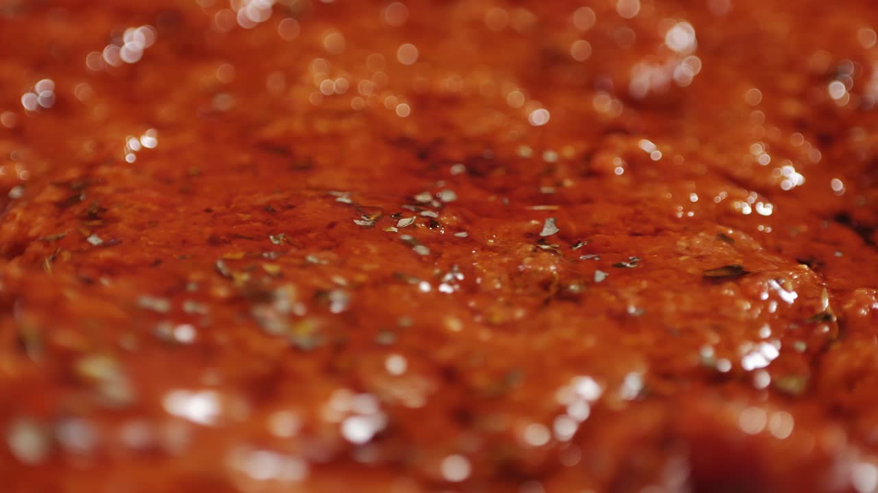 Cooking tomato sauce close-up. Classic homemade Italian tomato sauce for pasta and pizza in the pan. Chef cooking traditional Italian food. High quality 4k footage