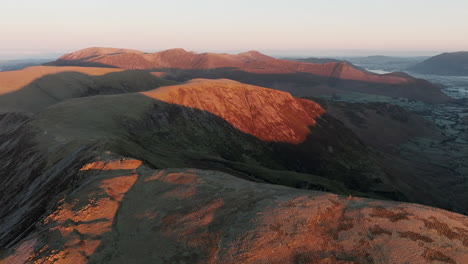 ancient cumbrian mountains bathed in dawn sunlight