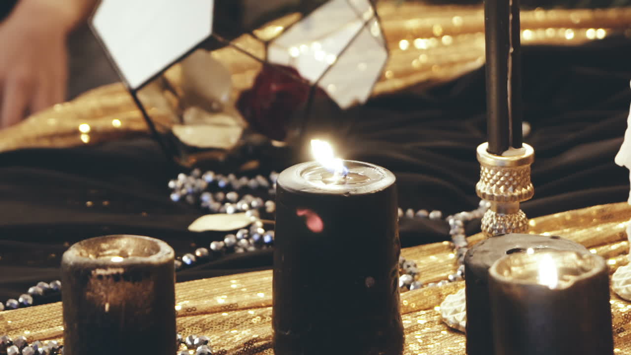 Woman with candle. Young witch woman casts a spell with candle in a room