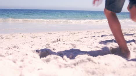 family running on the beach