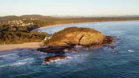 rotating drone shot of rocky outcrop on coast at scotts head austrialia