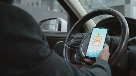 man using car sharing app