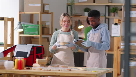 portrait of cheerful diverse colleagues at work in food delivery service