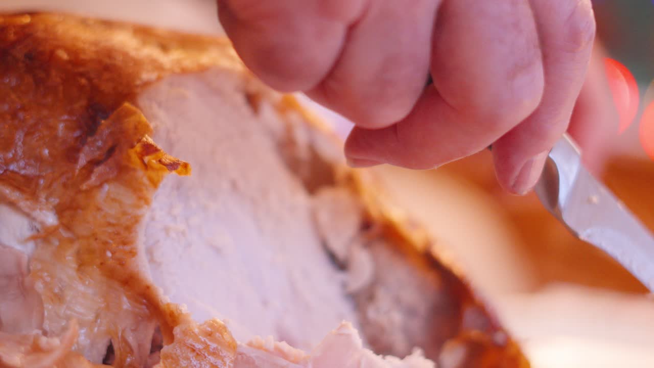 맛있는 긴 칠면조가 가족 식탁에서 조각되고 개지는 클로즈업 으로 맛있는 고기가 크리스마스 또는 추수감사절 휴가 기간 동안 가족이 즐길 수 있도록 포장됩니다.