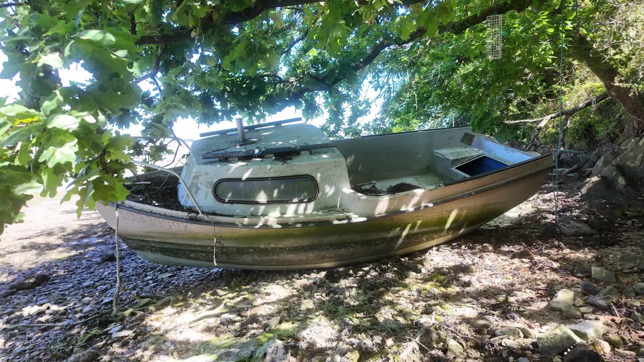 작은 유리 섬유 오두막 크루저 보트가 해변에 어졌습니다.