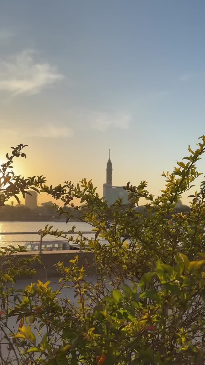 A view of buildings and bridge overlooking on Nile, close up shot, trucking shot