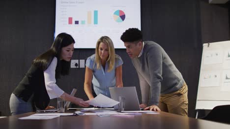 Video-of-diverse-female-and-male-coworkers-working-late-in-office