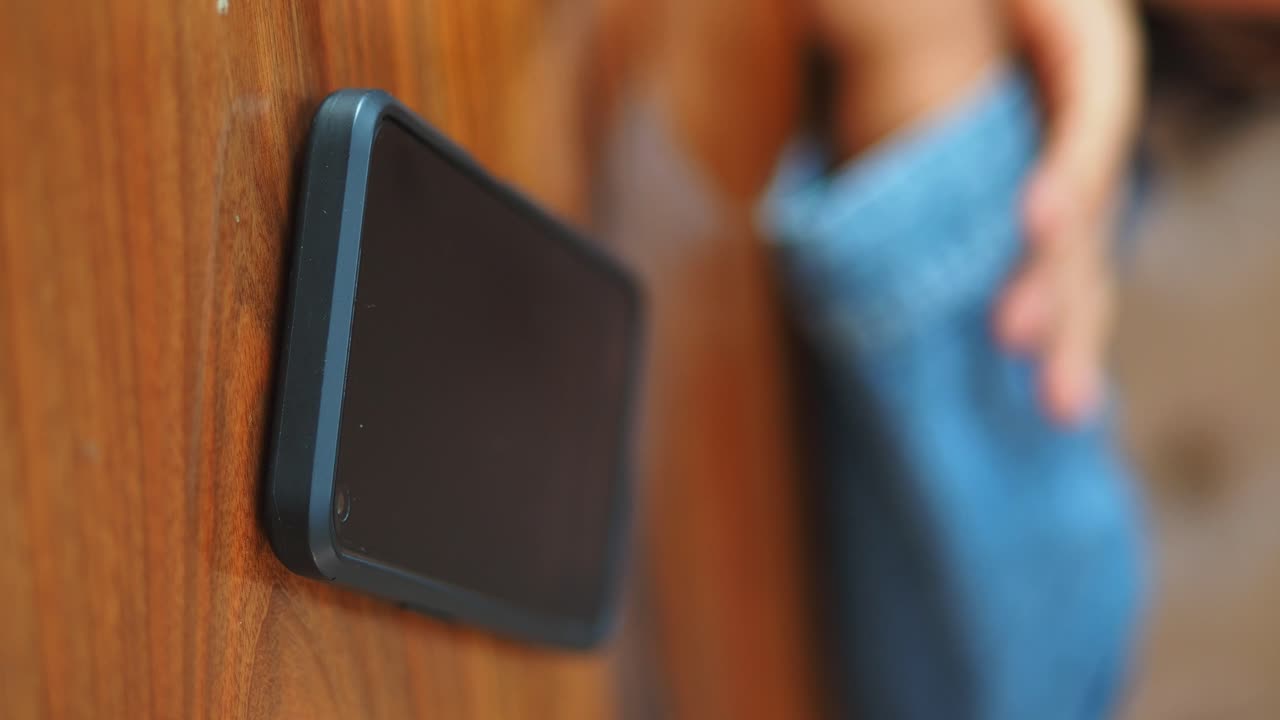 Smartphone on a wooden table being held by a person