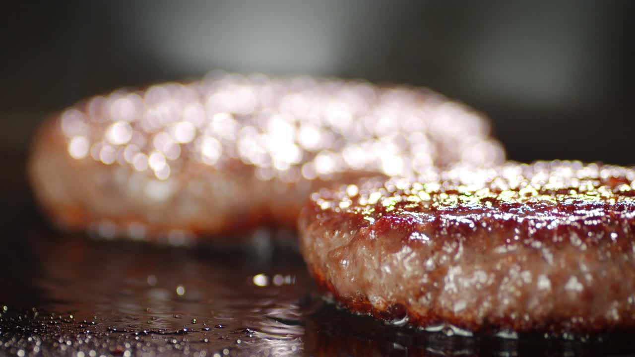 Cooking burger meat in a frying pan.