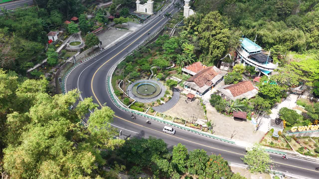 Aerial view of road traffic around the Gunung Kidul welcome monument