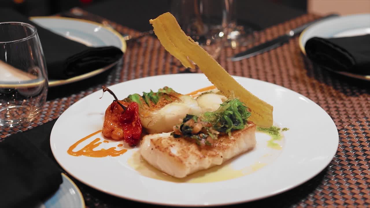 Close up haddock's plate on a white plate on the table of a fancy restaurant