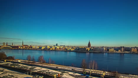 riga city and daugava river during golden sunrise, fusion 24 hours time lapse